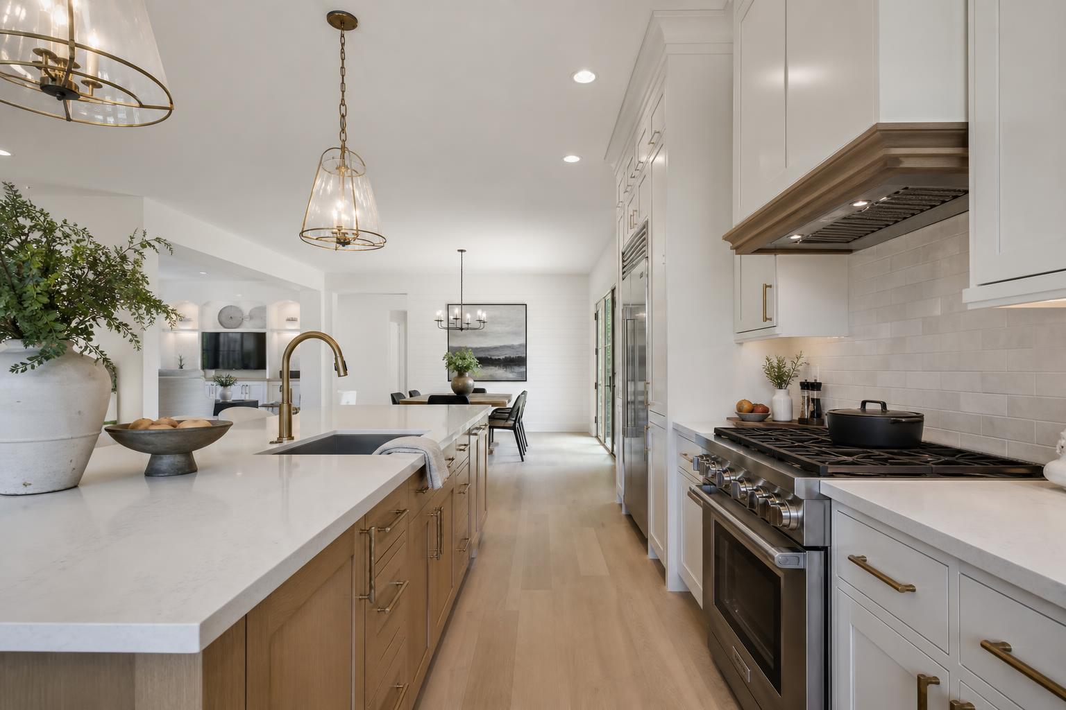 Open-concept kitchen with a large center island, pendant lighting, and white cabinetry — Cherry Hill, NJ remodel by HousePro